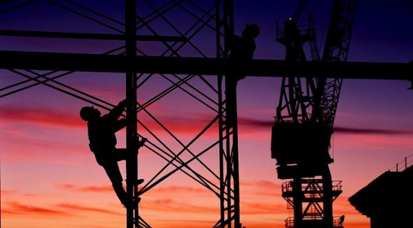 Workers climbing up scaffolding.