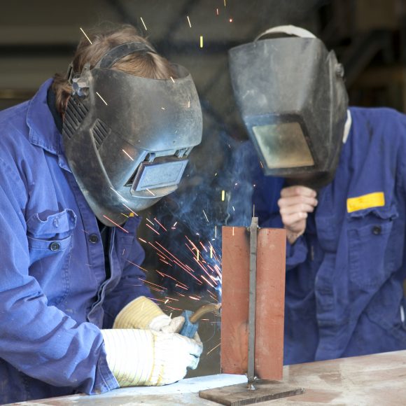 Factory workers welding.