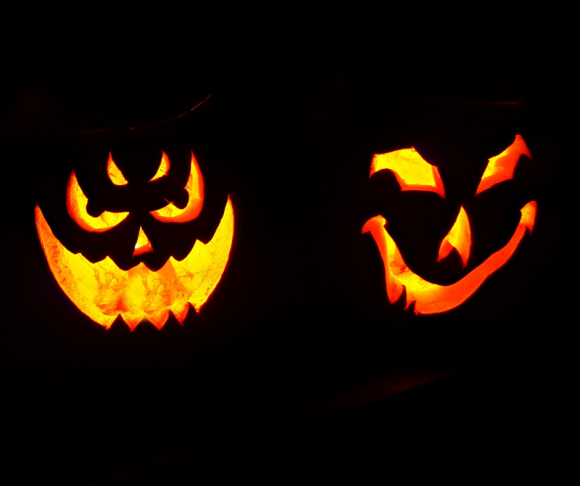 Lit-up carved Halloween pumpkins.