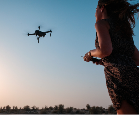 A girl flying a drone.