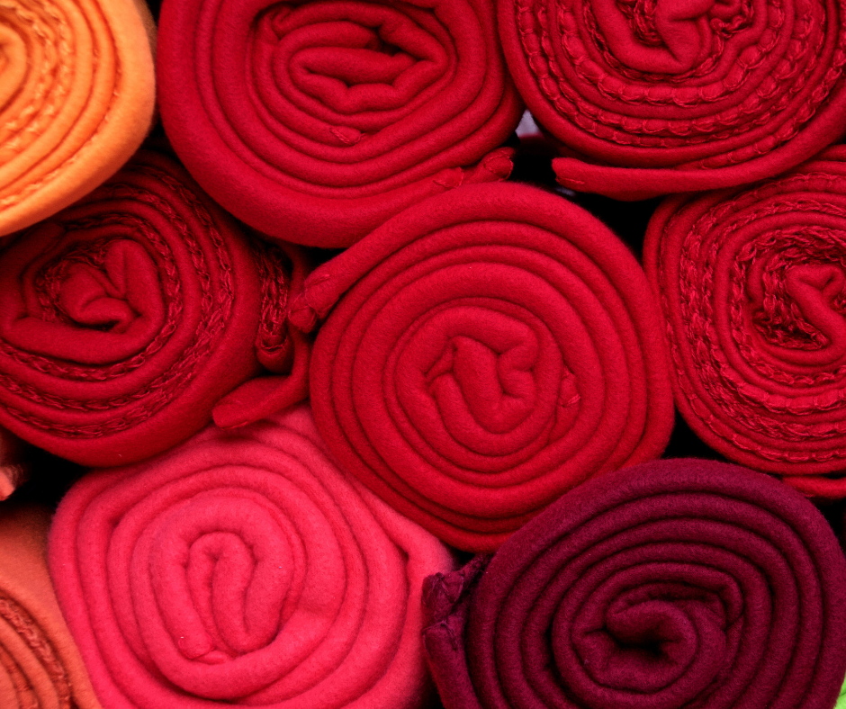 Rolled-up pieces of fabric in different shades of red.
