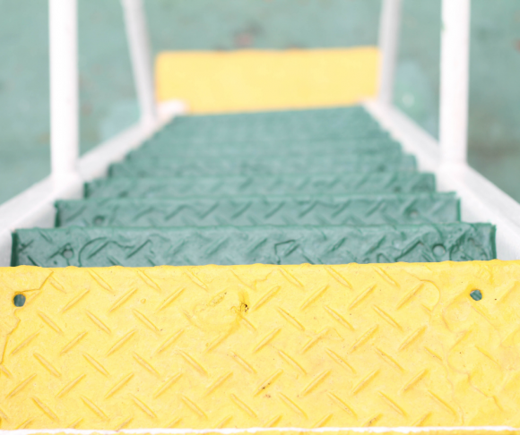 A ladder with green and yellow rungs.