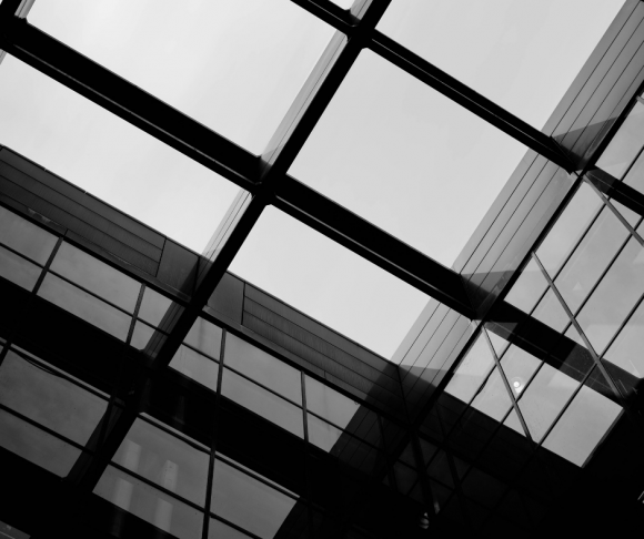 Windows on a building in black and white.