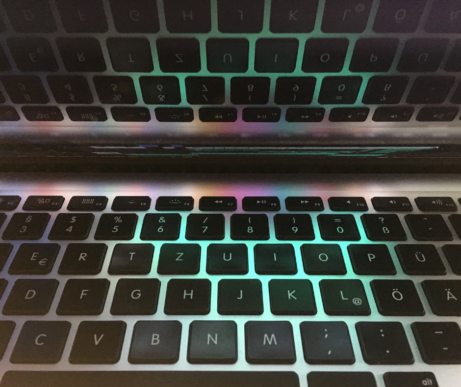 A close-up of a keyboard lit up with multi-coloured lighting.