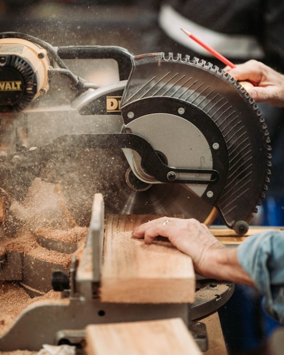 Cutting wood with a cross saw.