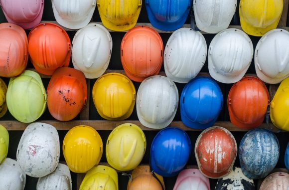 A collection of different coloured hard hats.