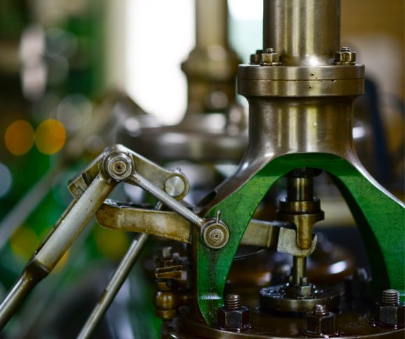 An up-close view of parts of a metal machine.