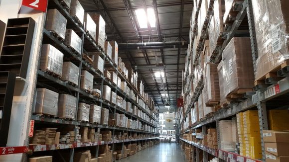 Industrial Warehouse Interior with ceiling-high shelves full of cardboard boxes.