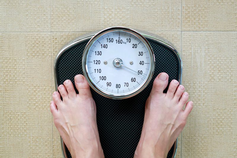 A person standing on weighing scales