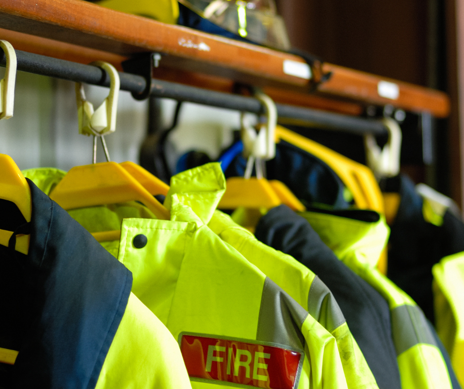 Firefighters uniforms hanging up on a rack