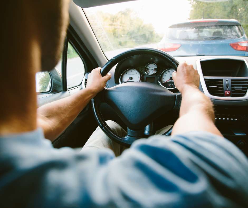 Over the shoulder view of someone driving a car