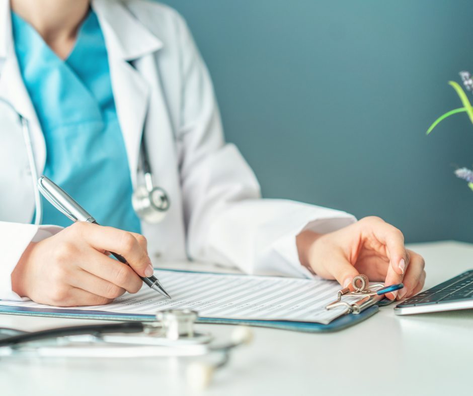 Person in a lab coat writing a report